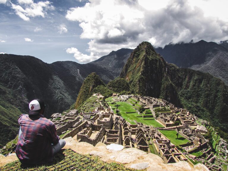 Inca Trail, Peru: A panoramic view of the historic Inca Trail, revealing ancient stone steps against a backdrop of lush greenery and mist-shrouded mountains. Discover the beauty and mystery of this iconic trek through the heart of the Andes.